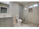 Modern bathroom featuring a walk-in shower, gray vanity, and built-in shower seat at 5538 N 63Rd Ave, Glendale, AZ 85301