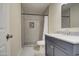 Modern bathroom with gray vanity and updated shower at 5538 N 63Rd Ave, Glendale, AZ 85301