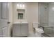 Updated bathroom with gray vanity, large mirror, and a walk-in shower at 5538 N 63Rd Ave, Glendale, AZ 85301