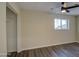 Bright bedroom with ceiling fan, large closet, and light-colored brick walls at 5538 N 63Rd Ave, Glendale, AZ 85301