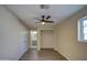 Bedroom with ceiling fan, wood-look flooring, and access to bathroom at 5538 N 63Rd Ave, Glendale, AZ 85301