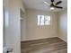 Well-lit bedroom with ceiling fan and built-in shelving at 5538 N 63Rd Ave, Glendale, AZ 85301