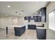 Updated kitchen with navy blue cabinets, large island, and modern appliances at 5538 N 63Rd Ave, Glendale, AZ 85301