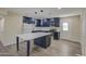 Updated kitchen featuring a center island and stylish dark blue cabinetry at 5538 N 63Rd Ave, Glendale, AZ 85301