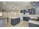 Modern kitchen with island, stainless steel appliances, and white quartz countertops at 5538 N 63Rd Ave, Glendale, AZ 85301