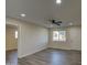 Bright and airy living room with wood-look floors and ceiling fan at 5538 N 63Rd Ave, Glendale, AZ 85301