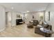 Living room with leather sofas, a piano, and wood flooring at 5715 S Winchester --, Mesa, AZ 85212