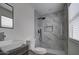 Modern bathroom with a large walk-in shower and updated vanity at 6145 W Pierce St, Phoenix, AZ 85043