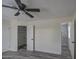 Spacious bedroom with a walk-in closet and ceiling fan at 6145 W Pierce St, Phoenix, AZ 85043