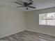 Bright bedroom with ceiling fan, window, and wood-look flooring at 6145 W Pierce St, Phoenix, AZ 85043