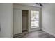 Bedroom with gray flooring, a large window, and a sliding door closet at 6145 W Pierce St, Phoenix, AZ 85043