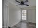 Well lit bedroom with gray vinyl flooring and a large window at 6145 W Pierce St, Phoenix, AZ 85043