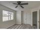 Well-lit bedroom with double closet and ceiling fan at 6145 W Pierce St, Phoenix, AZ 85043