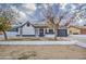 Cute single story home with a landscaped front yard and black garage door at 6145 W Pierce St, Phoenix, AZ 85043