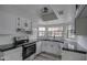 Updated kitchen featuring white cabinets and black countertops at 6145 W Pierce St, Phoenix, AZ 85043