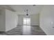 Spacious living area featuring gray wood-look vinyl flooring and sliding glass doors at 6145 W Pierce St, Phoenix, AZ 85043