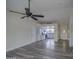 Bright living room with gray vinyl flooring and a view into the kitchen at 6145 W Pierce St, Phoenix, AZ 85043