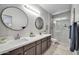 Elegant bathroom with dual sinks, modern fixtures, and a glass-enclosed shower at 7009 E Acoma Dr # 1004, Scottsdale, AZ 85254