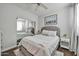 This bedroom features a mirrored closet, ceiling fan, and a gray tufted headboard above the bed at 7009 E Acoma Dr # 1004, Scottsdale, AZ 85254