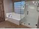 Bathroom features a soaking tub and glass shower at 7146 W Emile Zola Ave, Peoria, AZ 85381