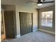 Bright bedroom with double doors and carpet at 7146 W Emile Zola Ave, Peoria, AZ 85381