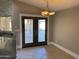 Dining area with French doors leading to the backyard at 7146 W Emile Zola Ave, Peoria, AZ 85381