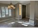 Bright entryway with tile floors, plantation shutters, and a dark-stained door at 7146 W Emile Zola Ave, Peoria, AZ 85381