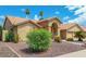 Tan house with tile roof, mature landscaping, and a three-car garage at 7146 W Emile Zola Ave, Peoria, AZ 85381