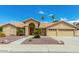 Tan two-story house with tile roof, three-car garage, and desert landscaping at 7146 W Emile Zola Ave, Peoria, AZ 85381