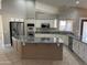 Large kitchen with an island, stainless steel appliances, and granite countertops at 7146 W Emile Zola Ave, Peoria, AZ 85381