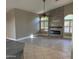 Bright living room with a fireplace and wood-look tile floors at 7146 W Emile Zola Ave, Peoria, AZ 85381