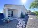 Exterior backyard features a walkway of stepping stones, with desert landscaping, and a covered patio at 7284 E Gamebird Way, San Tan Valley, AZ 85143