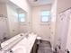 Bright bathroom featuring double sink vanity, a large mirror, and wood-style flooring at 7284 E Gamebird Way, San Tan Valley, AZ 85143