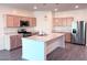 Well-lit kitchen features stainless steel appliances and a central island with marble countertops at 7284 E Gamebird Way, San Tan Valley, AZ 85143