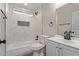 Clean bathroom with marble tile, a bathtub, and modern vanity at 7602 W Minnezona Ave, Phoenix, AZ 85033