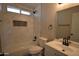 Updated bathroom with marble-look tile and modern fixtures at 7602 W Minnezona Ave, Phoenix, AZ 85033