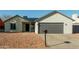 Newly renovated single-story home with a modern gray garage door at 7602 W Minnezona Ave, Phoenix, AZ 85033