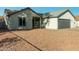 Newly renovated single-story home with a modern gray garage door at 7602 W Minnezona Ave, Phoenix, AZ 85033