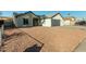 Single-story home with gray garage door and a gravel driveway at 7602 W Minnezona Ave, Phoenix, AZ 85033