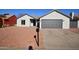 Newly constructed home with a gray garage door and rock landscaping at 7602 W Minnezona Ave, Phoenix, AZ 85033