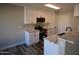 Modern kitchen with white shaker cabinets and quartz countertops at 7602 W Minnezona Ave, Phoenix, AZ 85033