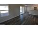 Living room with vinyl plank flooring and sliding glass doors to backyard at 7602 W Minnezona Ave, Phoenix, AZ 85033