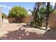 Landscaped backyard with trees, cacti, and brick patio at 7729 N Via De Fonda --, Scottsdale, AZ 85258