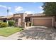 Front view of a tan house with a tile roof, and a two car garage at 7729 N Via De Fonda --, Scottsdale, AZ 85258