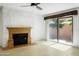 Living room with fireplace and sliding glass doors to backyard at 7729 N Via De Fonda --, Scottsdale, AZ 85258