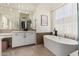 Elegant bathroom with soaking tub and double vanity at 8951 E Wethersfield Rd, Scottsdale, AZ 85260