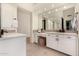 Bright bathroom features a double vanity and large mirror at 8951 E Wethersfield Rd, Scottsdale, AZ 85260