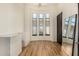 Bedroom with hardwood floors, large windows and a full-length mirror at 8951 E Wethersfield Rd, Scottsdale, AZ 85260