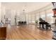 Open dining area with hardwood floors and a view of the kitchen at 8951 E Wethersfield Rd, Scottsdale, AZ 85260