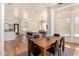 Open concept dining area with light wood table and view of living room at 8951 E Wethersfield Rd, Scottsdale, AZ 85260